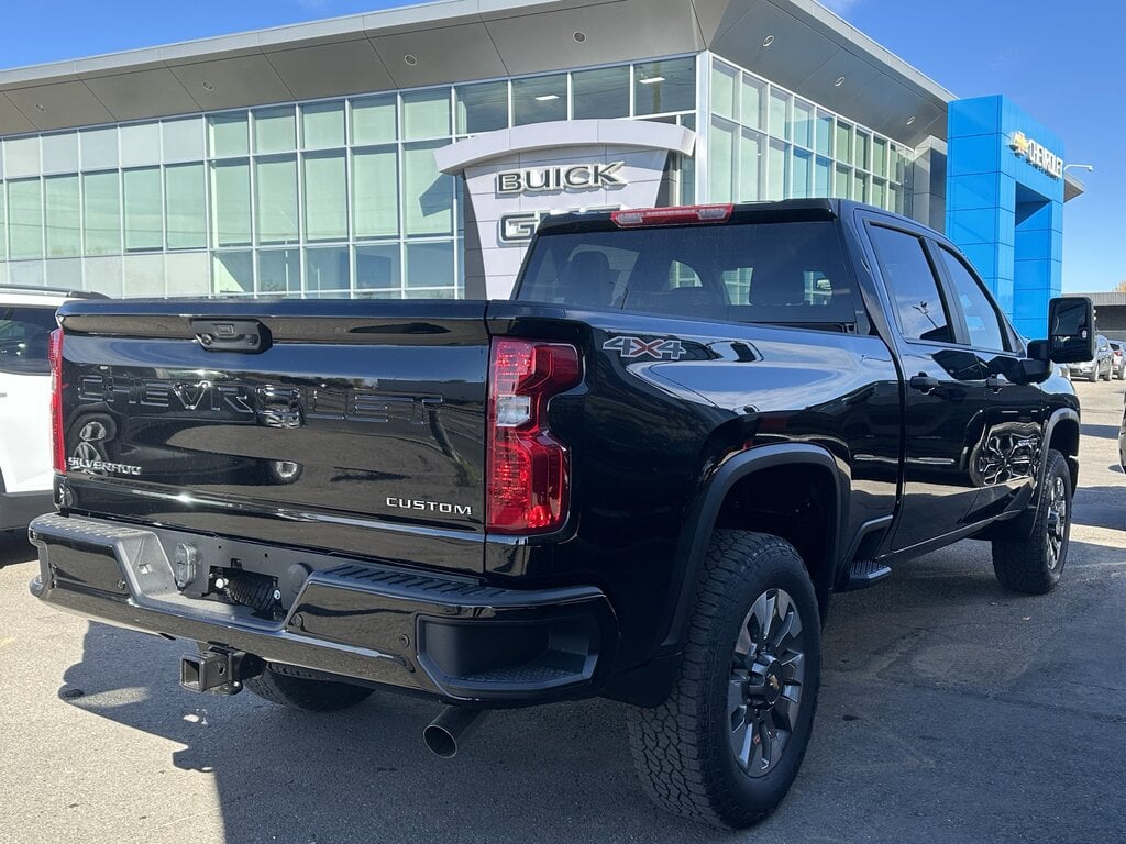 3/4 rear view of the Chevy Silverado 2500HD, showcasing its truck bed and hitching system.