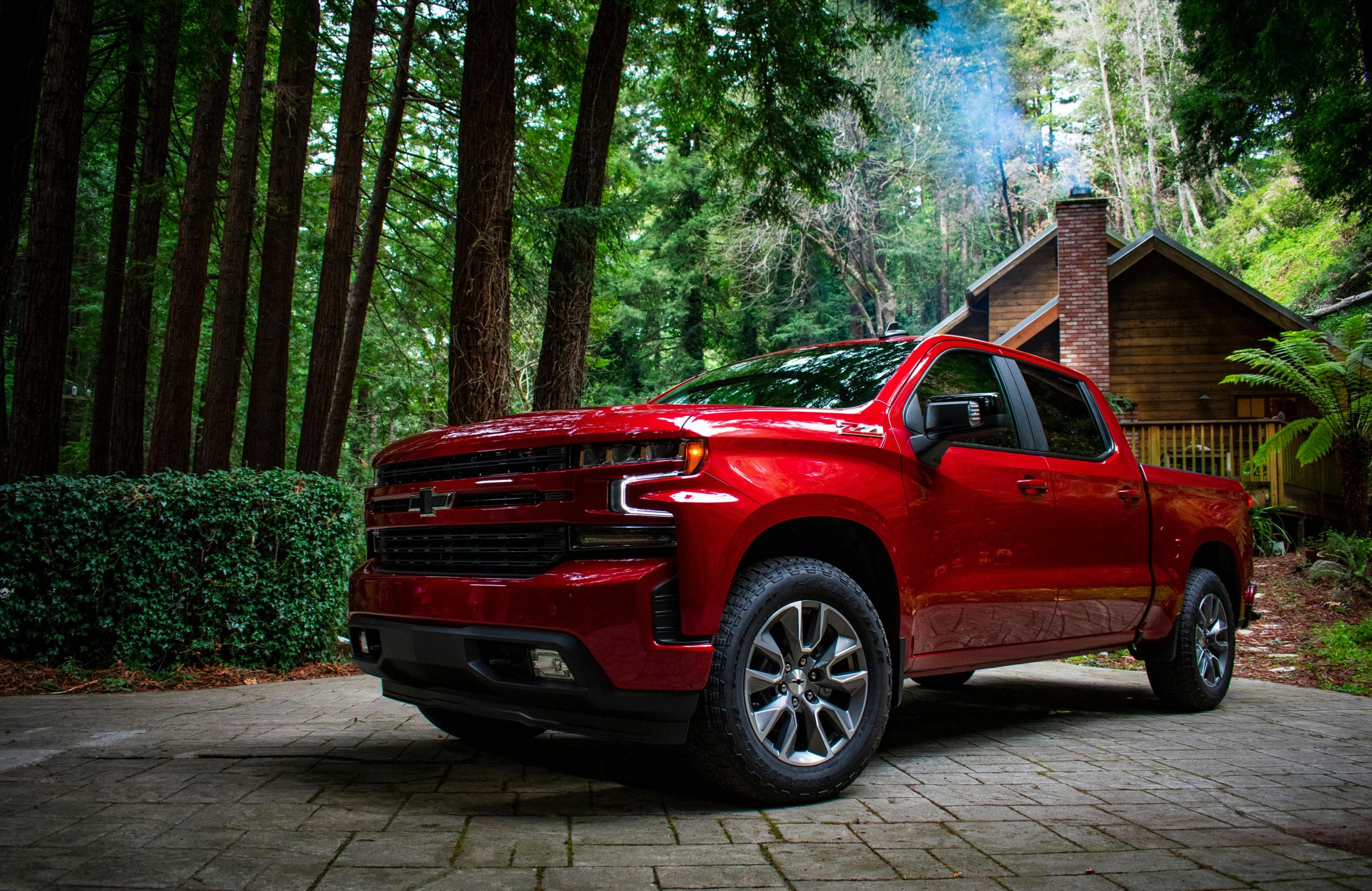 3/4 view of a Chevrolet Silverado 1500 parked in a forested driveway