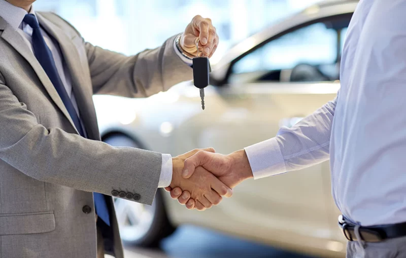 Customer receiving vehicle keys with a handshake