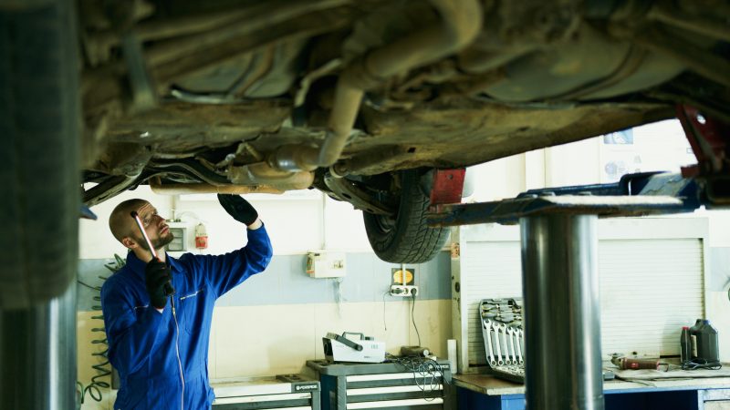 A mechanic working on the engine of a vehicle in preparation for spring