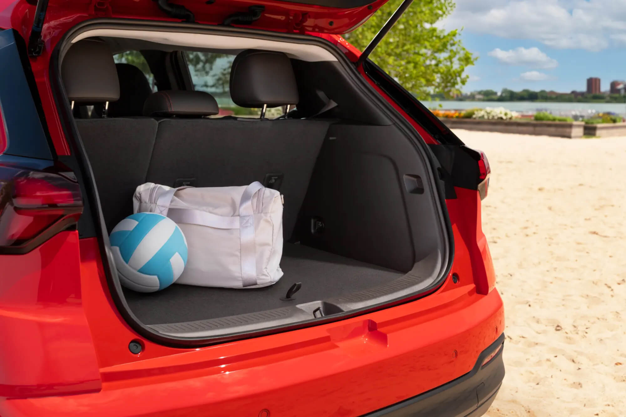 Open Chevrolet Bolt cargo area with everyday bags and a ball
