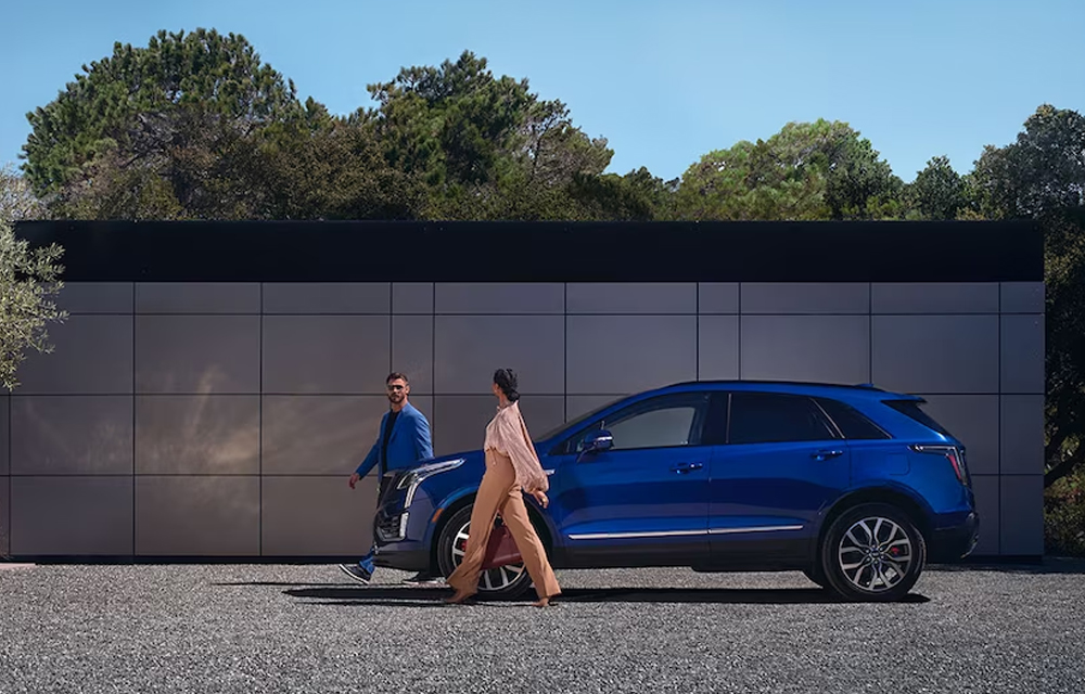 People walking around Cadillac XT5