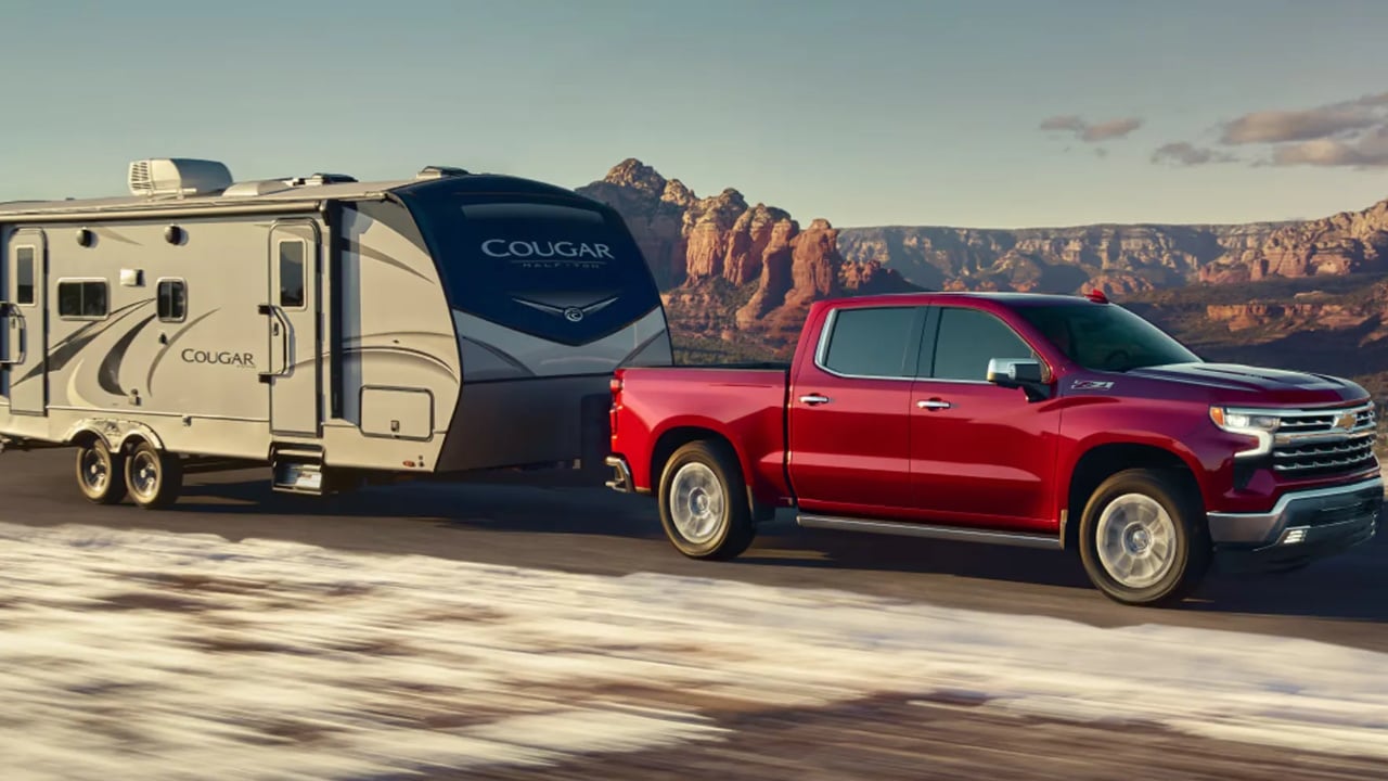 vue latérale avant d'un Chevrolet Silverado 1500 2026 avec une remorque