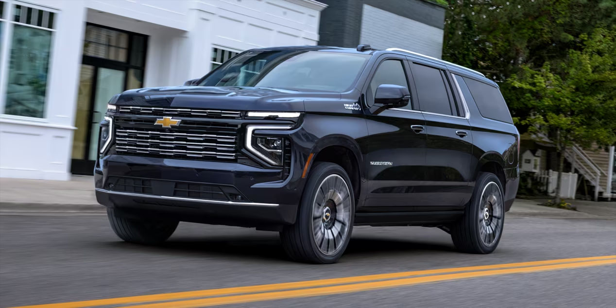 2025 chevrolet suburban black driving on road slider_widget-106-0